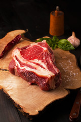 Raw beef steak with salt, garlic and spices