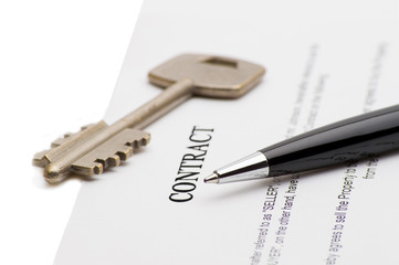 Keys of a new house and pen on contract. 
