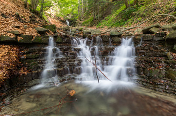 Obraz premium Waterfall on Mosorny creek, Beskid Zywiecki mountain range in Polish Carpathian Mountains