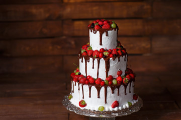 Strawberry cake on a wooden background.
