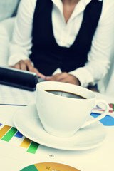 businesswoman using an electronic calculator in her office