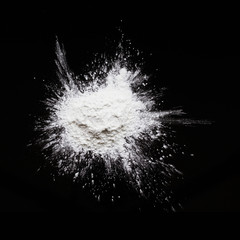White powder explosion isolated on black backgroun