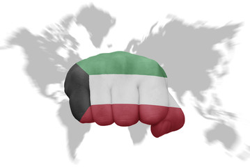 fist with the national flag of kuwait on a world map background
