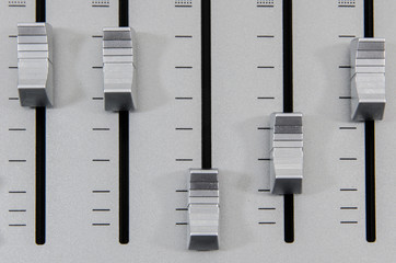 closeup of chrome decibel level slider buttons