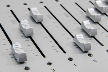 closeup of slider buttons forming diagonal lines