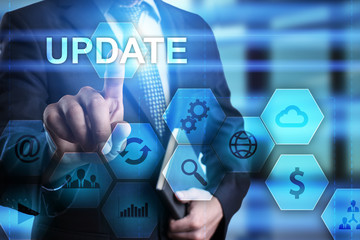 Businessman is pressing button on virtual screen and selecting Update.