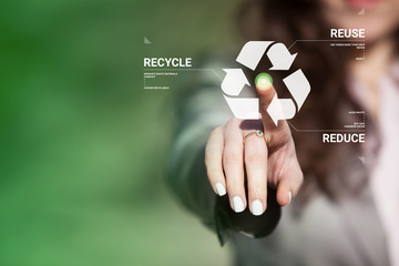 Businesswoman touching recycling symbol on virtual touch screen. Environmental concept recycle - reduce - reuse. - obrazy, fototapety, plakaty
