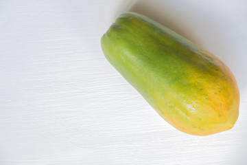 papaya on white wooden background