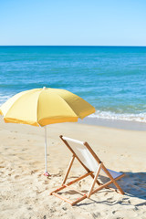 Chair and umbrella on stunning tropical beach background vacation 