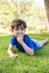 Boy holding a magnifying glass