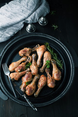 Fried chicken legs with spices, rosemary and mint