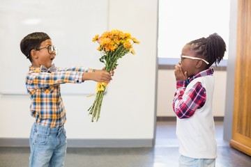 Schoolboy giving a bunch of flowers to a girl - Powered by Adobe