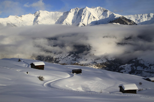 View of snowcapped mountain range and chalets
