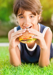 Happy boy eating burger