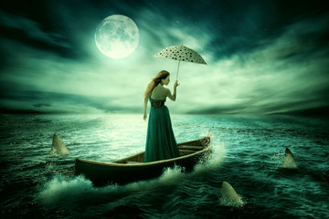 Young lonely woman with umbrella drifting on boat after storm surrounded by sharks