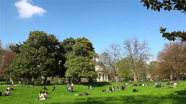 People have a rest in the Monceau park in Paris