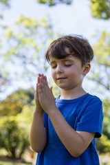 Fototapeta premium Boy praying with eyes closed