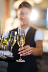 Waitress offering a glass of champagne 