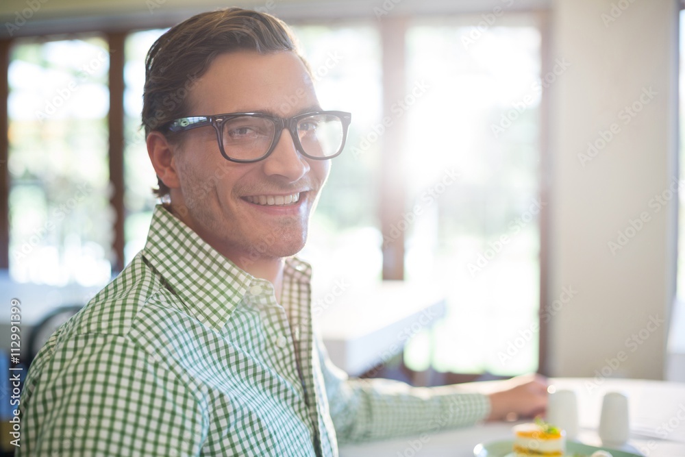 Poster portrait of smiling man having a lunch