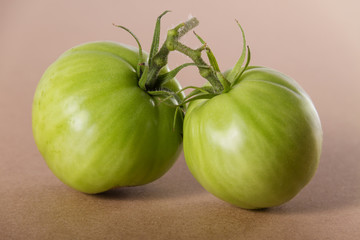 Fresh homegrown green tomatoes on wooden background.