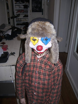 Kid with scary clown mask.