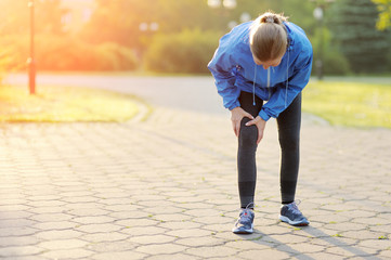 Fototapeta premium Injuries - sports running knee injury on woman.