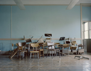 Old, broken chairs in an abandoned school