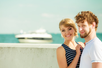 Fototapeta na wymiar Tourist couple in marina against boats sea water