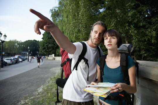 A young backpacker couple looking at a city map