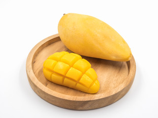 Ripe mango on wooden tray.