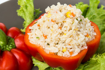 Stuffed peppers with rice and vegetables on black Plate