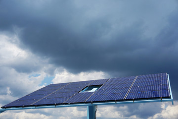 single solar panel in solar power station under storm cloud