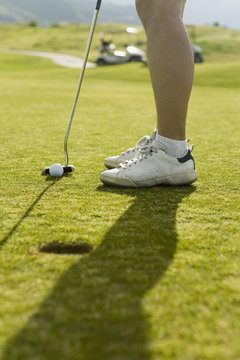 Detail of a golfer putting