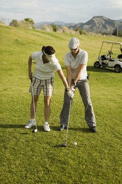 A golf instructor advising a golfer, Palm Springs, California, USA