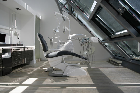 An empty chair in a dental examination room