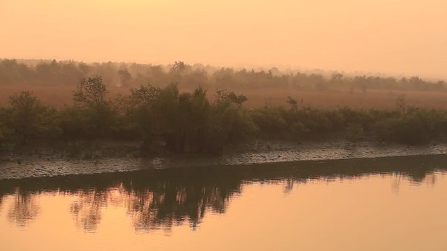 Cruise boat on the river from the town of Mrauk-U to Sittwe during dawn. Myanmar