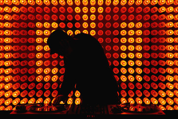 A DJ scratching a record in a nightclub