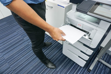 A man is printing document  copy a document