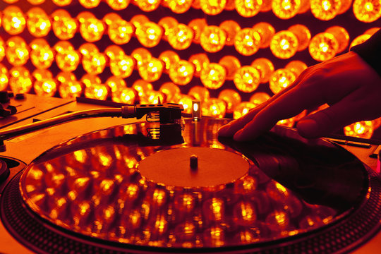 A DJ scratching a record at a nightclub