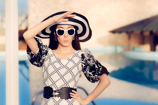 Surprised  Woman With Sunglasses and Sun Hat by the Pool 