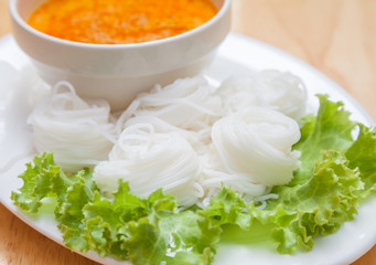 Rice noodles in fish curry sauce with vegetables