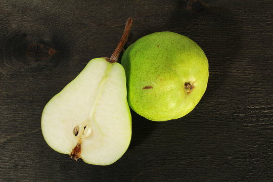 fresh pears in black wooden background