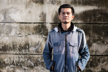 Obraz premium Asian young man wearing jeans clothes stand on the ground in fro