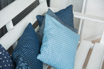 Close-up of blue cushions lie on a wooden
