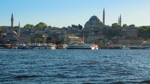 Turkey, Istanbul. The Waterfront. The lights of the city and Rustem Pasa Mosque. Pleasure ships and yachts. Evening. Time lapse 4K