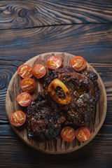 Top view of ossobuco served with cherry tomatoes, studio shot