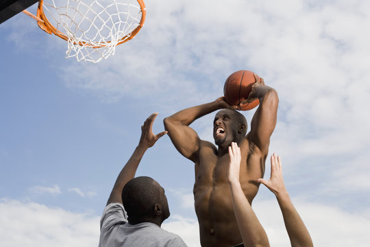 A basketball player preparing to make a slam dunk