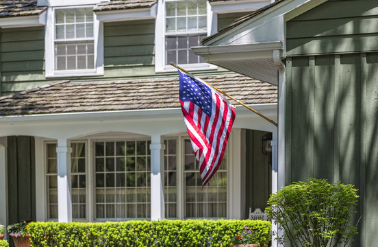 American flag in front of typical american house