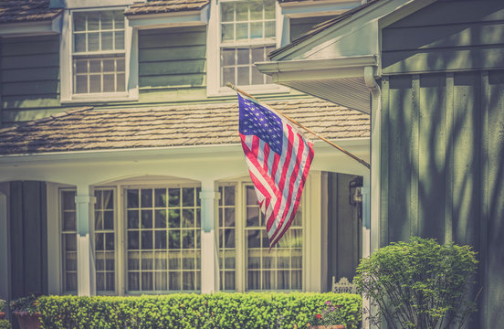 American flag in front of typical american house