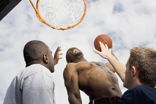 A basketball player preparing to make a slam dunk